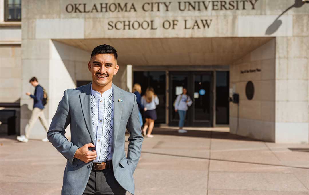student in front of OCU Law building entrance