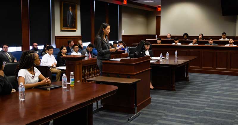 student in a mock courtroom